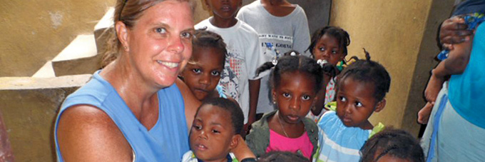 Jamie Schumacher with kids in Haiti
