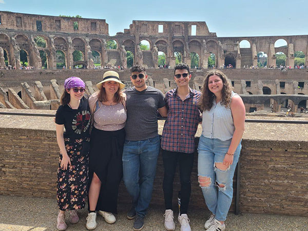 Students posing inside of the ruins of the Coliseum