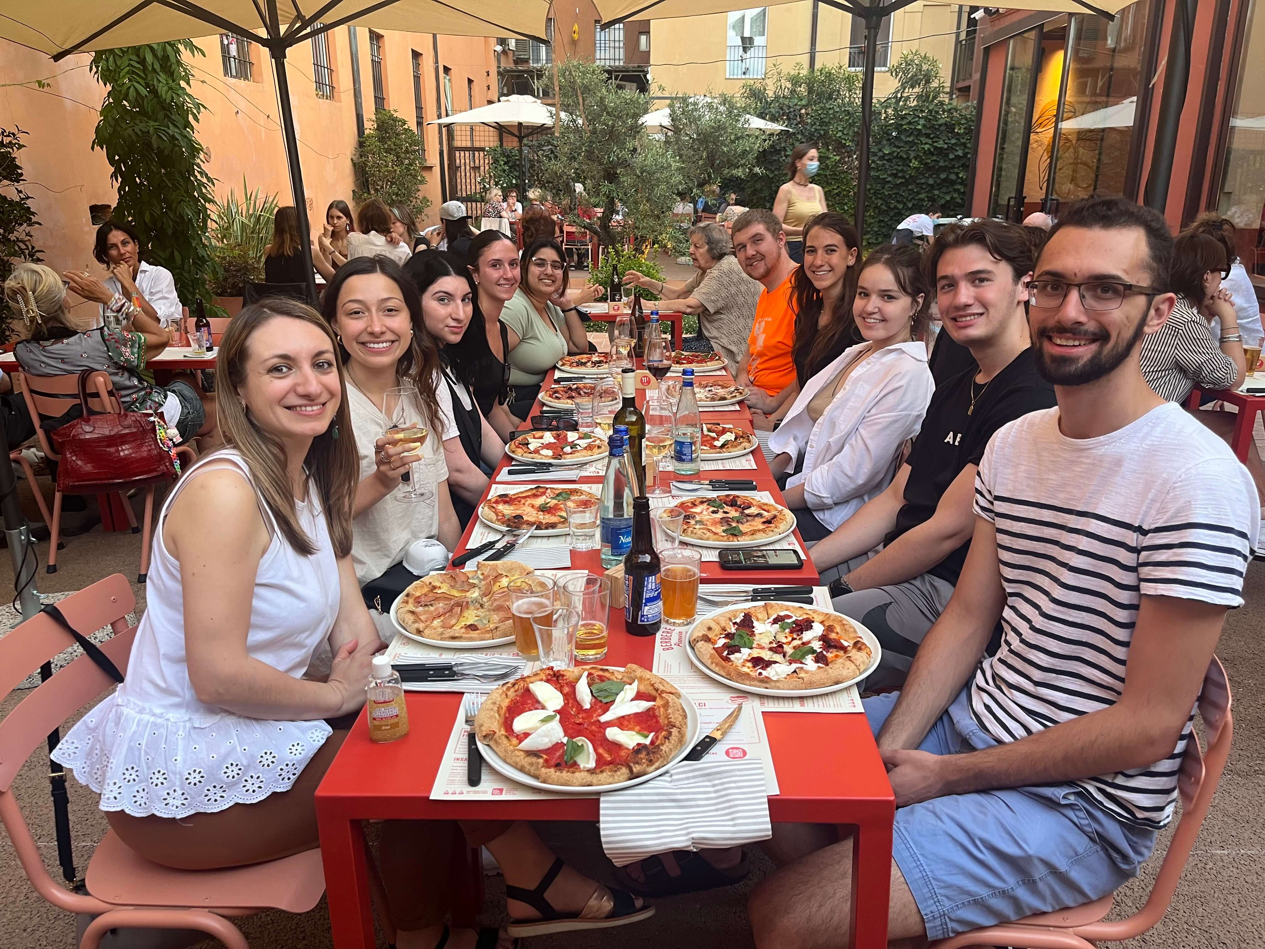 Students eating pizza in Italy